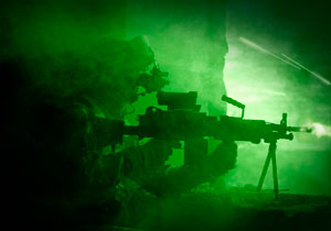 U.S. Army Ranger in a firefight during a night operation.