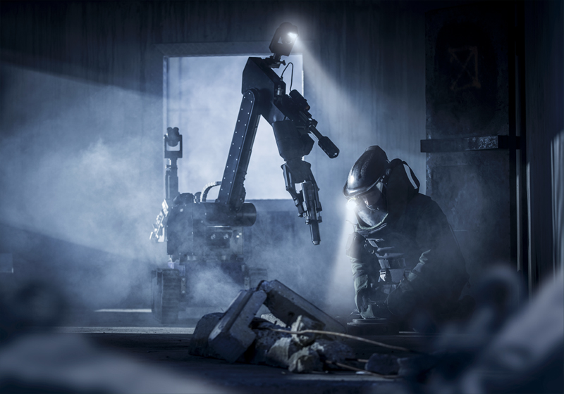 An EOD (Explosive Ordnance Disposal) specialist disarms a bomb with the help of a robot.