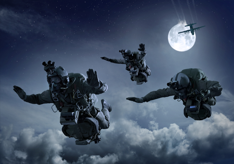 Special Operations Forces Parachutist with night vision goggles in freefall during a night operation.