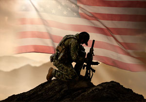 U.S.. Navy Seal kneels on a hill with an American flag in the background.