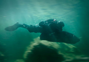 A Special Operations Forces combat swimmer with a diver propulsion vehicle.