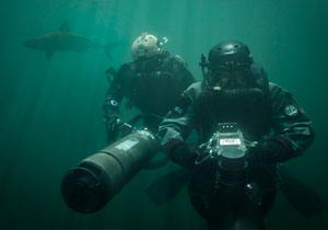 Two Special Operations Forces combat diver with diver propulsion vehicle.