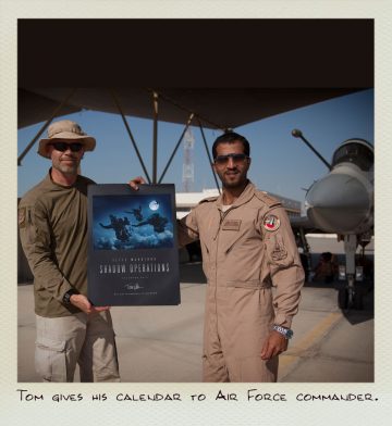 Tom (MILPICTURES) gives his calendar to the Air Force Commander.