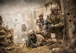 Special operations forces soldiers in a combat mission between house ruins.