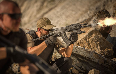 Mercenaries fire their rifles.