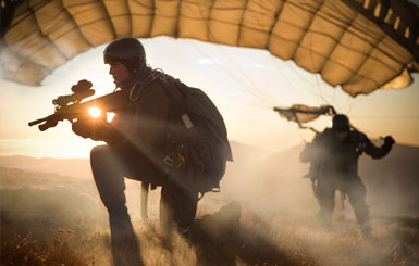 Special Operations Forces paratroopers secure the landing zone in the sunset.